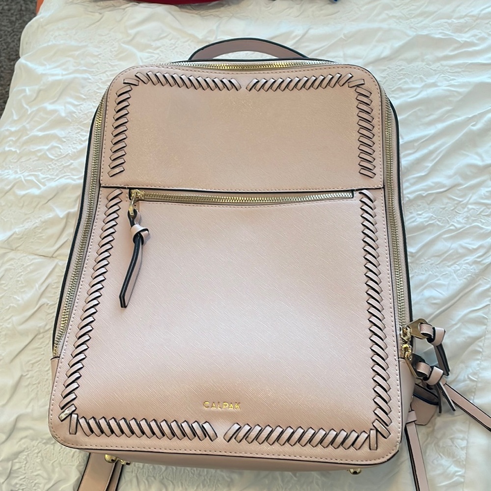 Light pink CALPAK laptop backpack